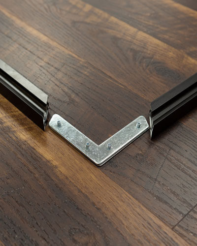 A corner closeup of the frame of a wall art piece used to demonstrate some of the pros and cons of framed wall art