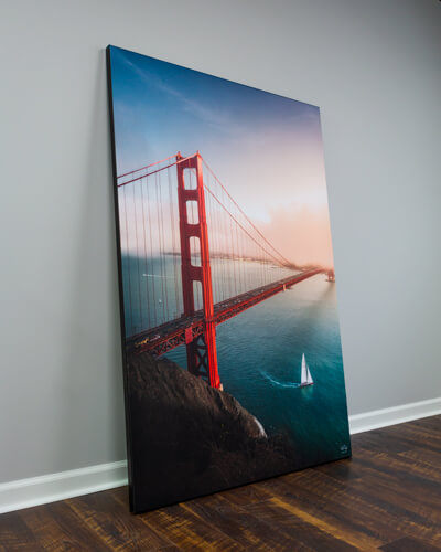 A large wall art piece leaning against the wall used to demonstrate some of the pros and cons of framed wall art