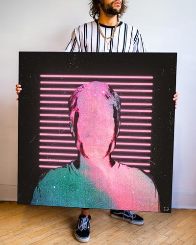 An artist holding a pink trippy wall art piece