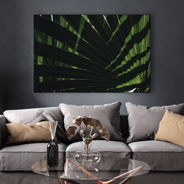 Fall wall art in Pantone Autumn 2022 color Amazon green of palm fronds hung in gray living room
