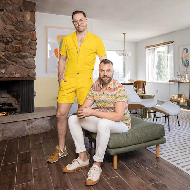 Interior designers and famous actors pose in living room of Joshua Tree Airbnb living room that they just redecorated in luxurious Palm Spring Style