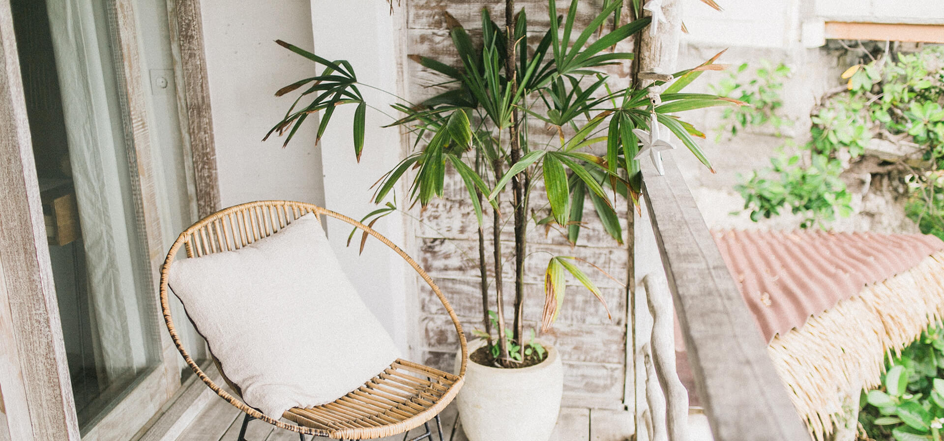 Rattan furniture sitting on boho inspired balcony