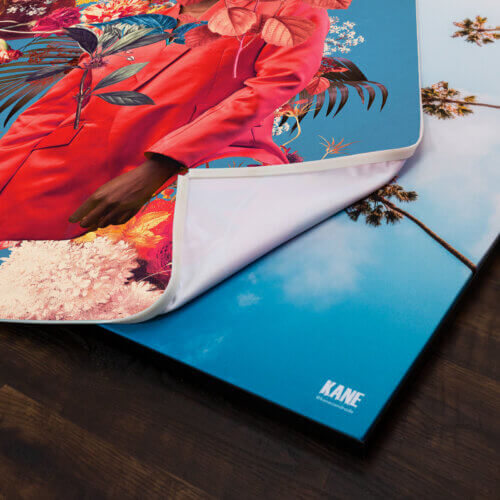 A fabric art print being swapped out of a sleek frame.