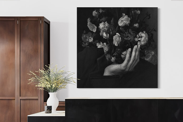 An office space featuring a striking surreal portrait wall art with a woman figure and florals in black and white, adding a creative and sophisticated ambiance.