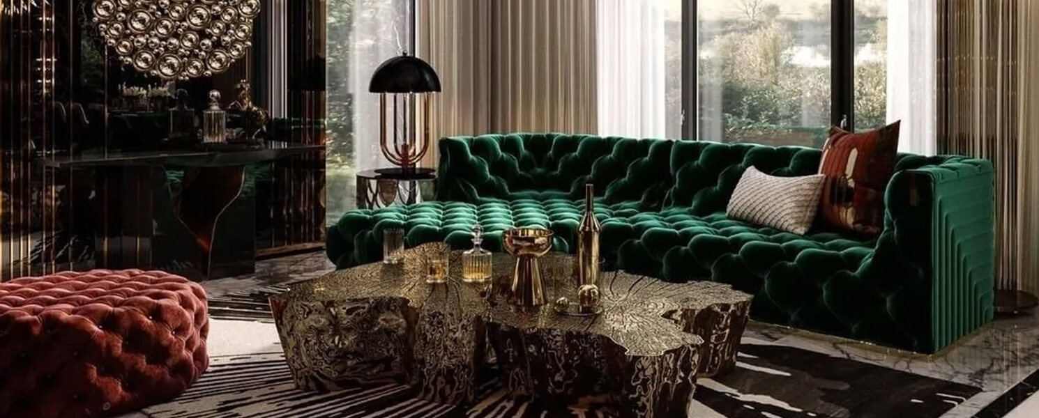 Dark luxury living room with emerald green velvet sofa, gold decor, and organic wood coffee table.