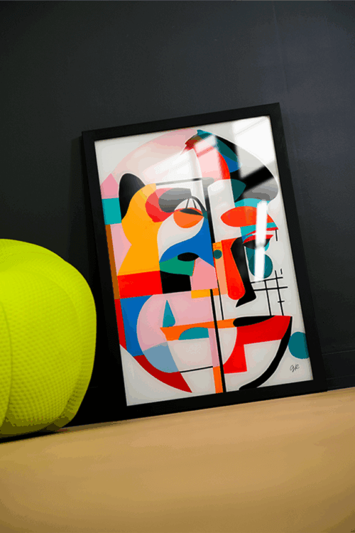 A framed geometric abstract infused acrylic print with bold red, blue, black, and orange shapes, leaning against a dark wall beside a lime green ottoman.