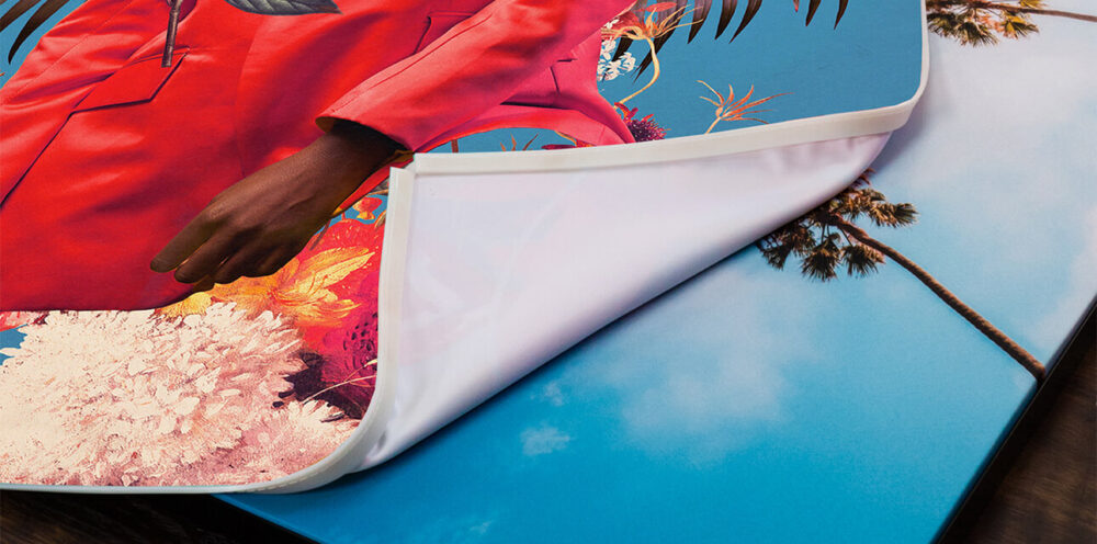 Close-up of a high-quality fabric print being easily swapped out of a sleek, swappable frame.