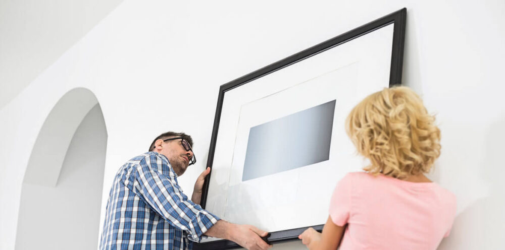 A couple hanging wall art used to demonstrate some of the pros and cons of framed wall art