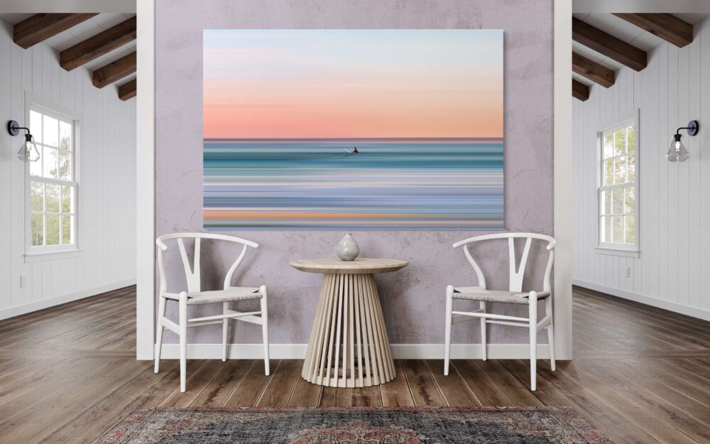 Extra large surreal wave wall art in blue and orange hangs above sitting area in beach house Airbnb