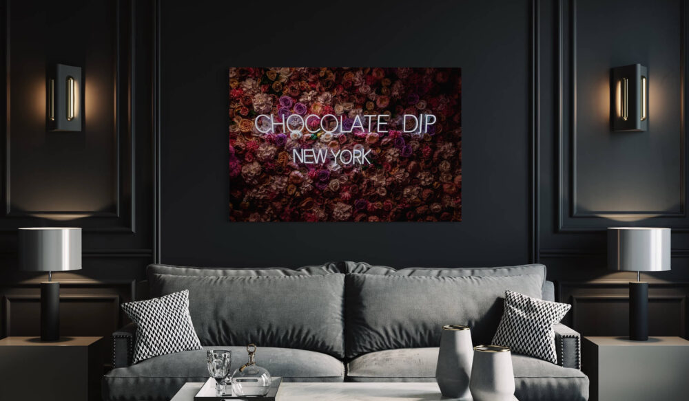 Oversized photography of a magenta rose wall with neon sign Chocolate Dip New York hangs in big city Airbnb