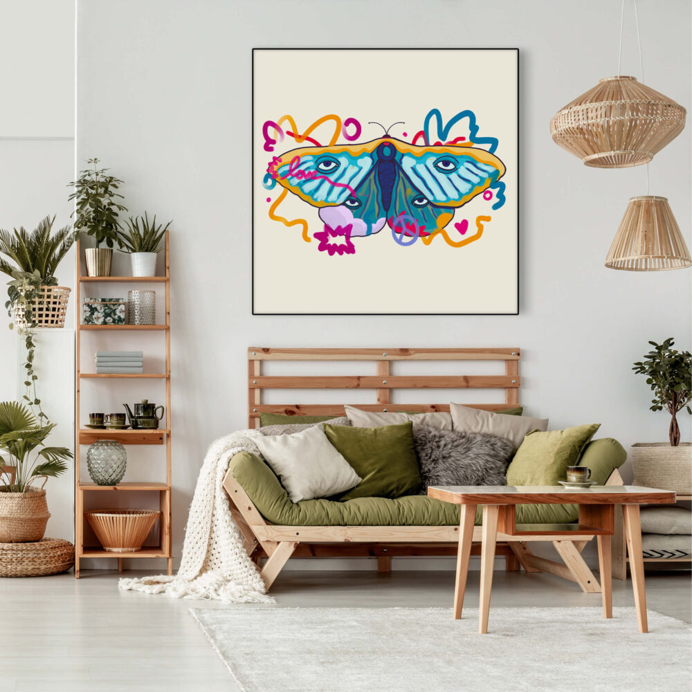 Massive boho print of moth painting hangs above couch in boho living room
