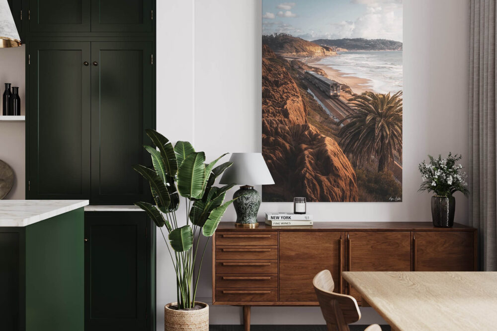Coastal landscape of rocky beach with train moving through the center of the photo hun in green kitchen