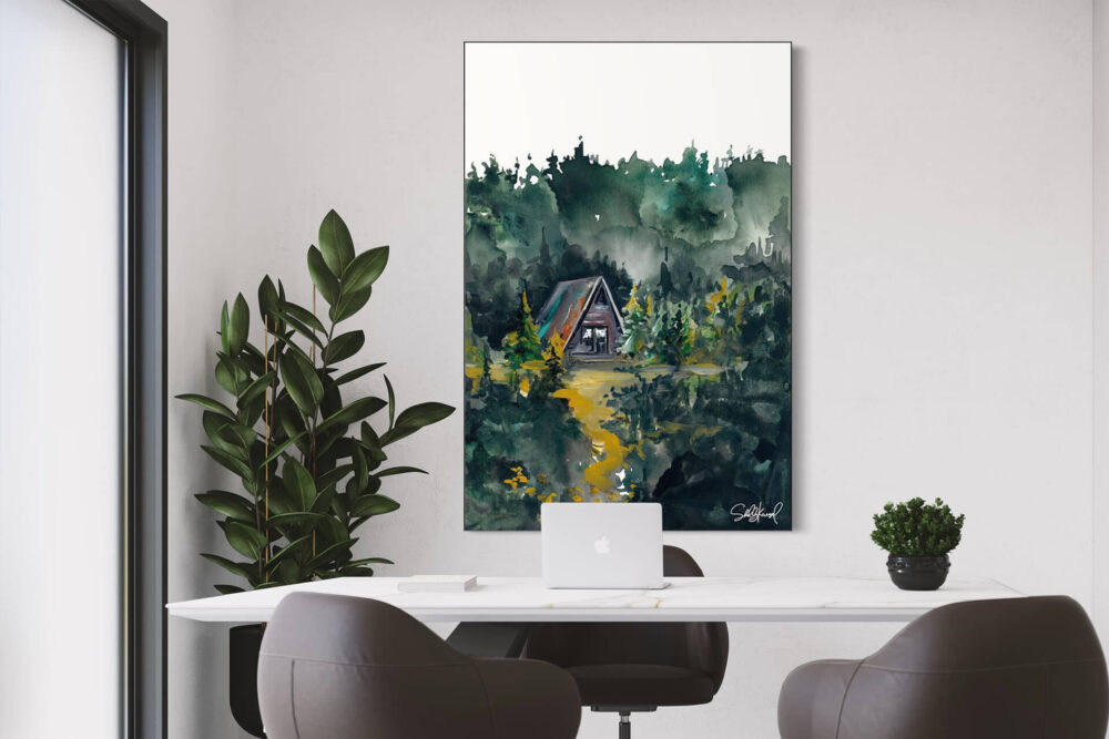 Large nature watercolor painting of A-frame cabin in the woods hangs on white wall above desk in modern office.