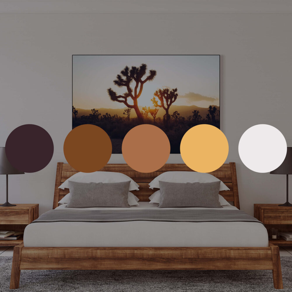 Landscape photo of Joshua Tree forest at sunrise hangs above the bed in neutral bedroom.