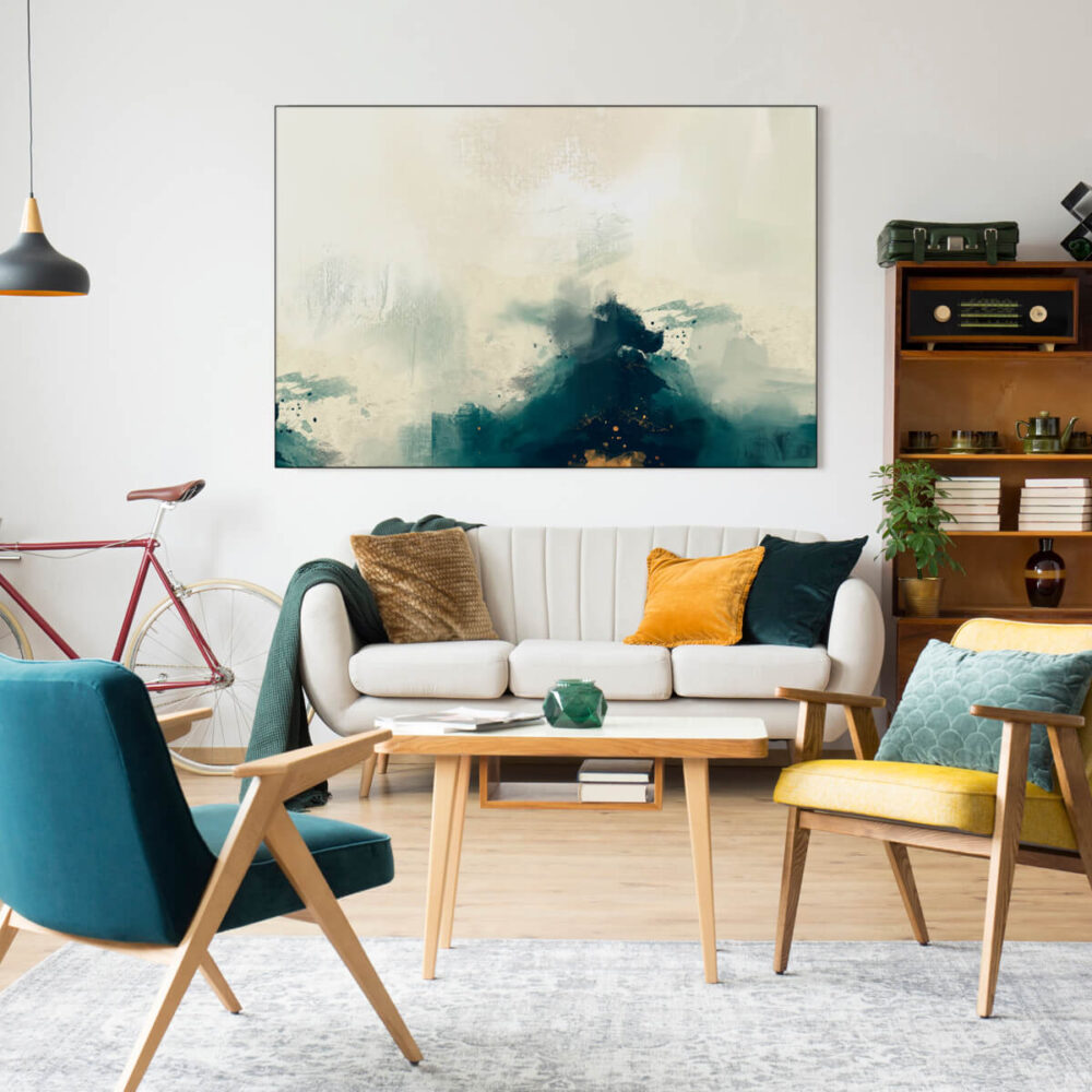 Artwork hanging on modern living room wall above couch features a color palette of blue, white, with accents of gold.