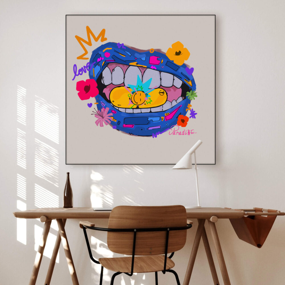 a desk with a piece of pop art hanging on the wall above it, featuring a colorful cartoon mouth with a yellow pill in it.