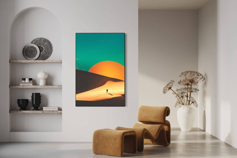 Surreal desert sunset landscape in yellow and teal hangs on white wall in neutral living room