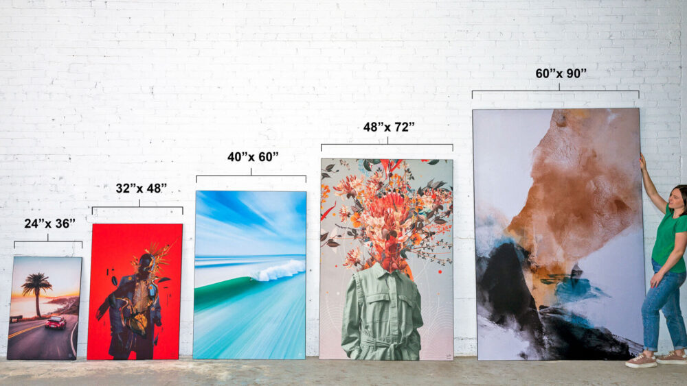 Five large pieces of colorful wall art are lined up against white wall in ascending order of height from left to right.