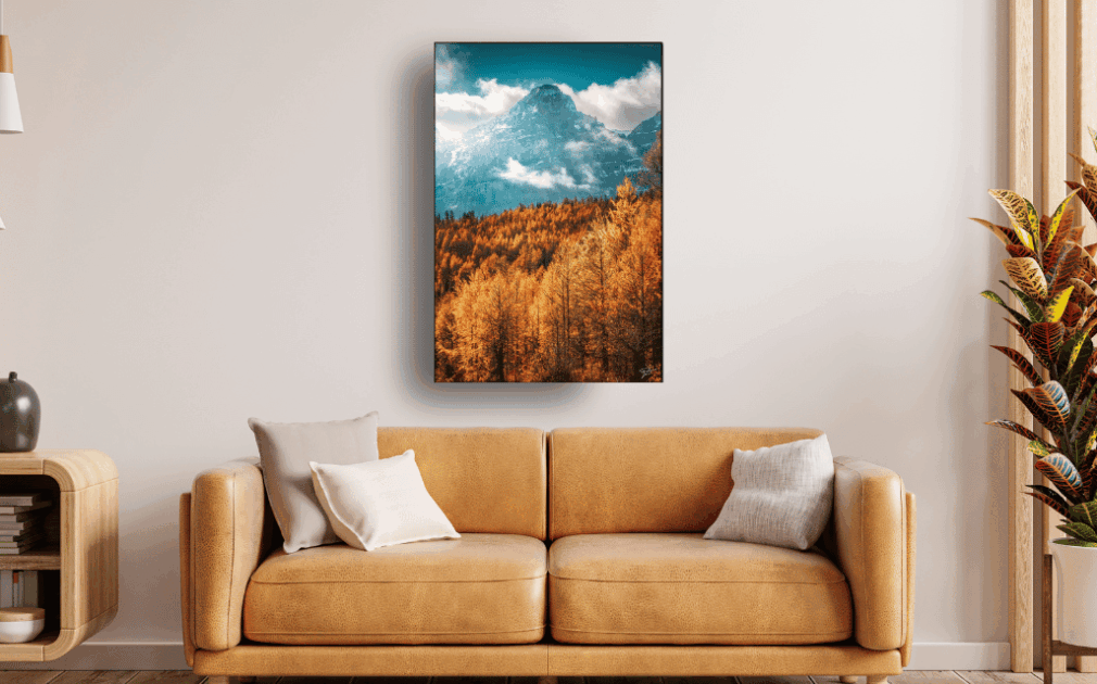 living room with fall wall art hanging over a yellow couch