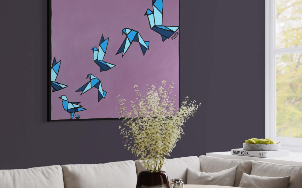 Purple pop art with blue painted origami birds flying across hangs above kitchen table