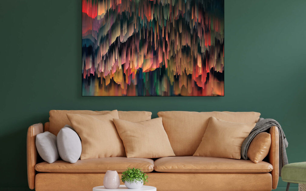 Oversized colorful digital abstract painting of colors dripping down hangs on dark green wall in living room.
