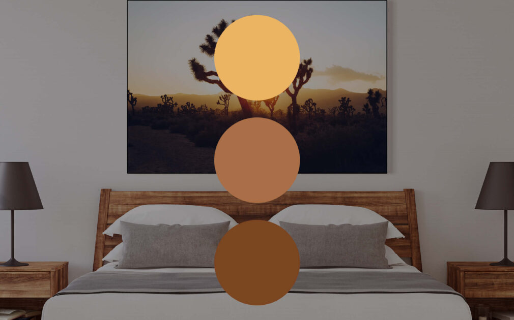 Landscape photo of Joshua Tree forest at sunrise hangs above the bed in neutral bedroom.