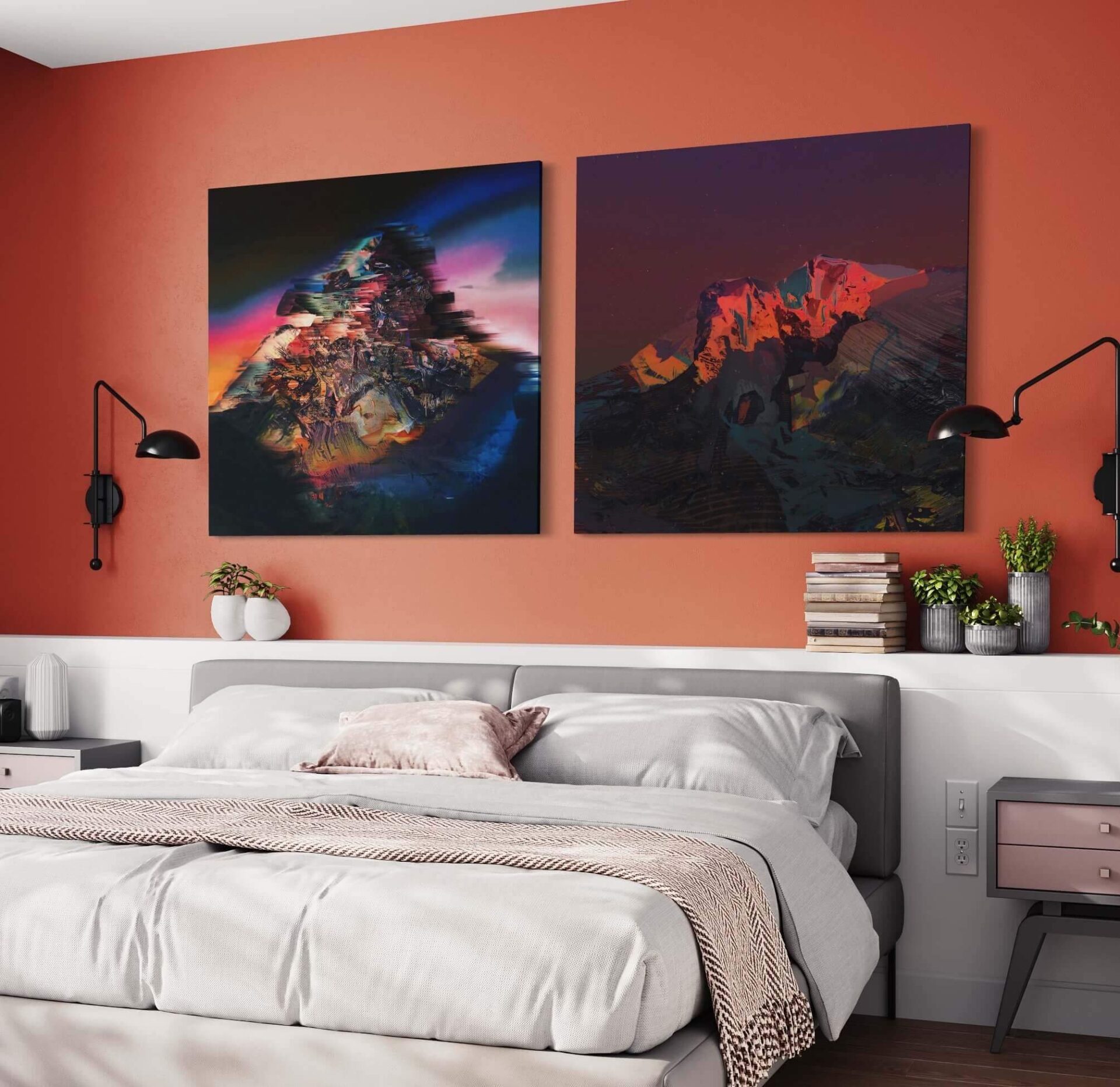 Abstract wall art of mountains at sunset hang side by side on orange wall above bed in bright bedroom