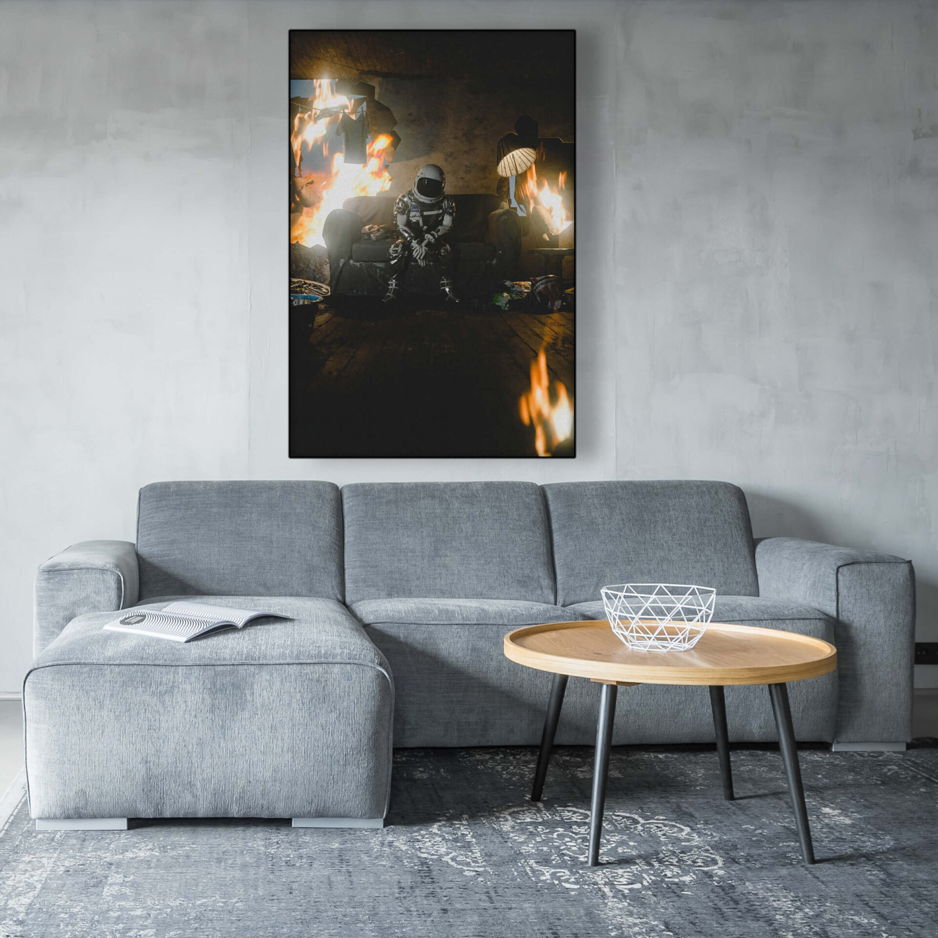 Oversized surreal astronaut art of astro in burning house hangs above gray couch