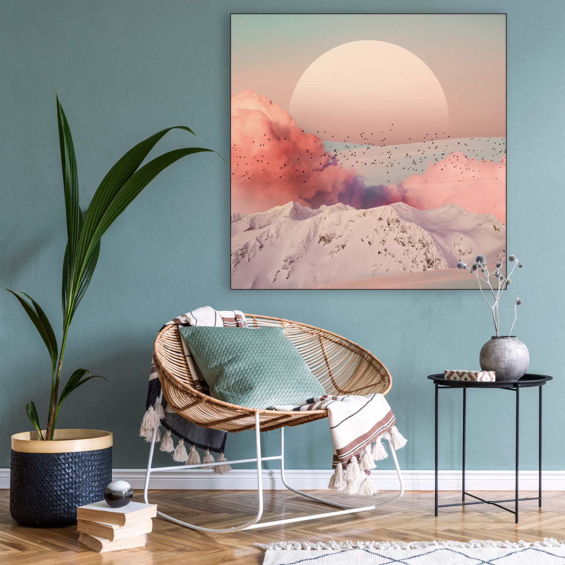 Massive pink boho wall art of surreal sunset hangs on blue wall in living room
