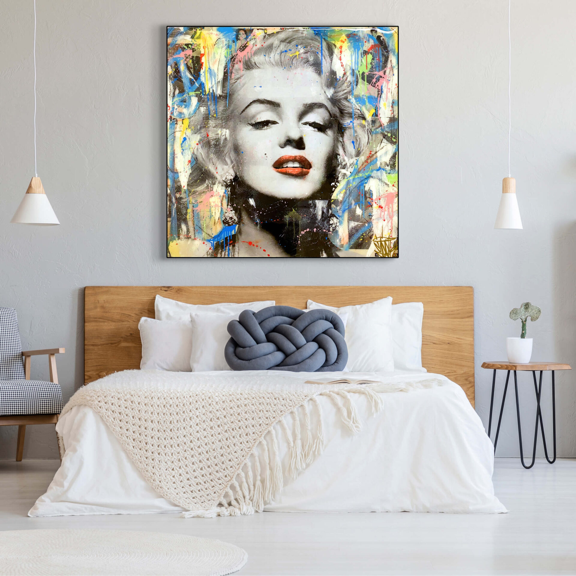 Massive square pop art of Marilyn Monroe hangs above white bed
