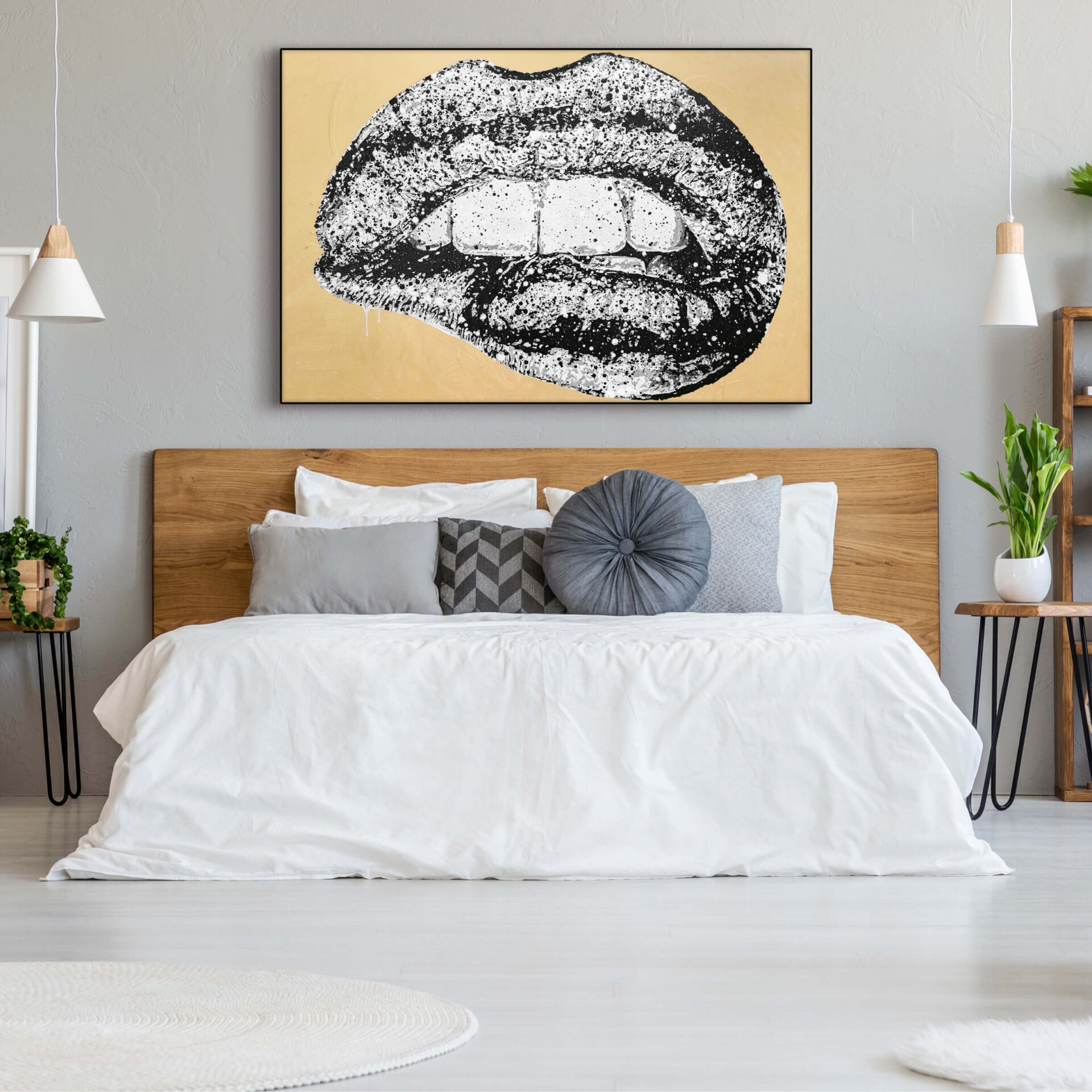 Oversized black and white painting of lips being bitten suggestively hangs above white bed