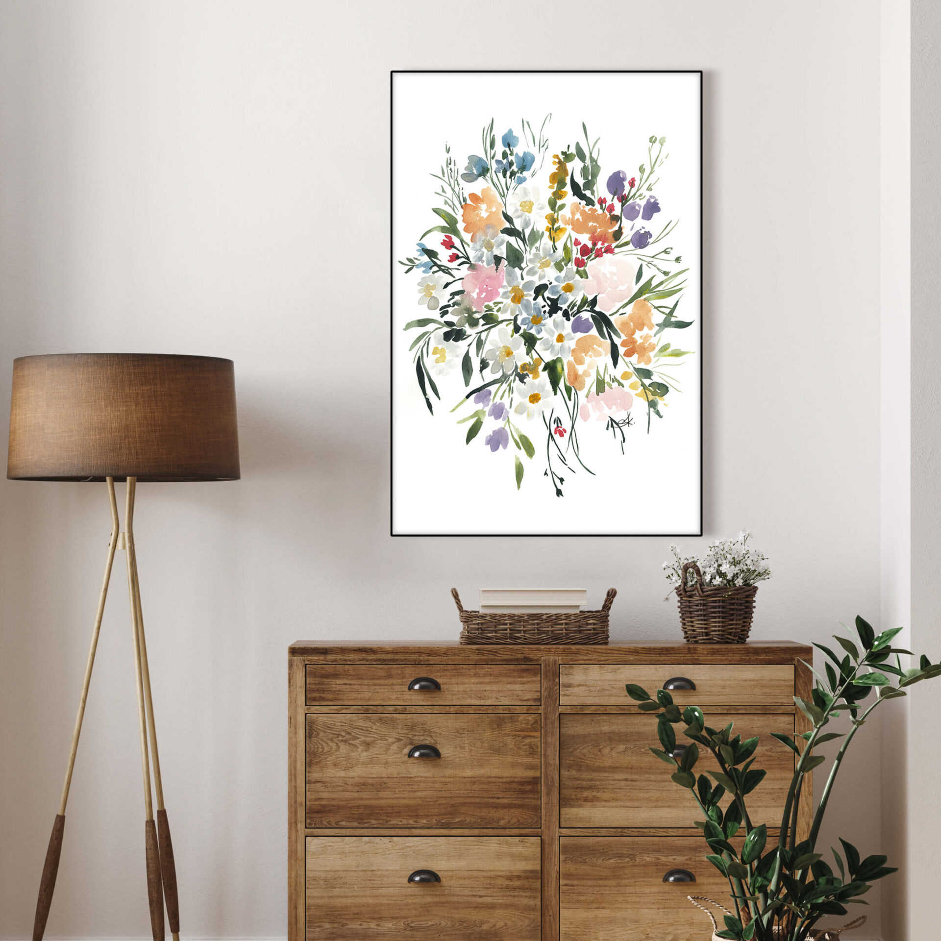 Hand-painted watercolor wildflower bouquet hangs on white wall in modern bedroom.