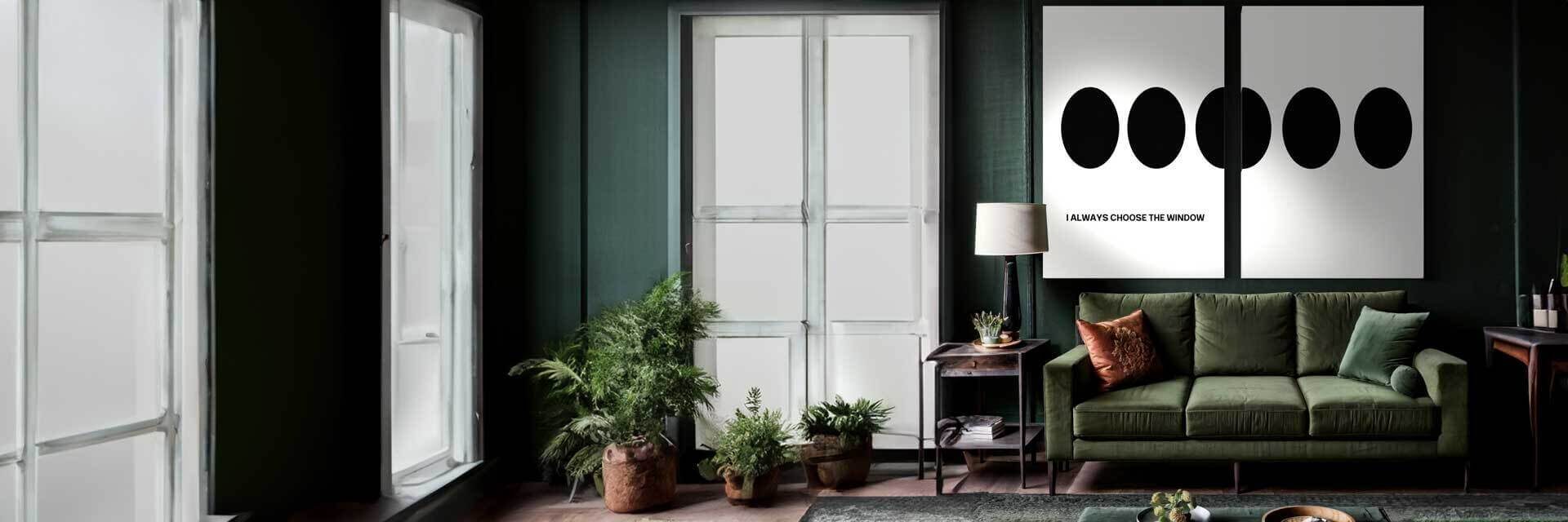 Horizontal view of a large dark green room with hardwood floors. To the right is a long green couch accompanied by an end table and lamp. Above the couch is the focal point, a two piece set of artwork by George Rosaly that goes together. The artwork is a minimal style white background. The artwork is split into two prints, the left print has a phrase and 2 and a half dots. The second print has the other half of the 2 and a half dots.