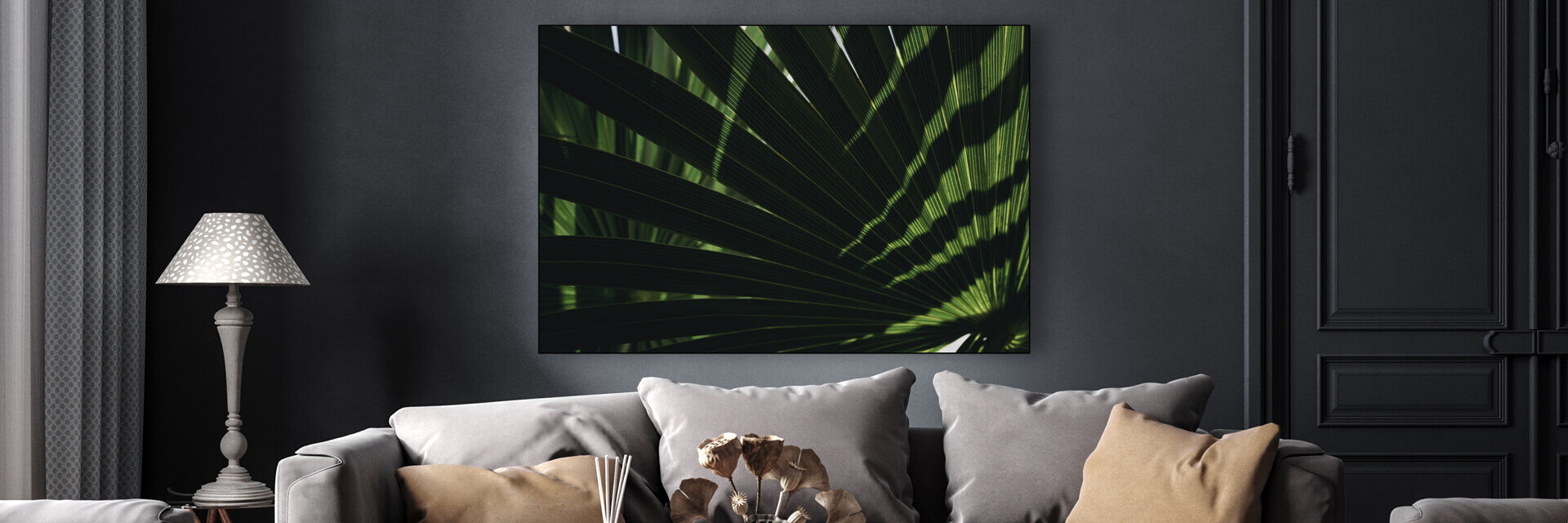 Fall wall art in Pantone Autumn 2022 color Amazon green of palm fronds hung in gray living room
