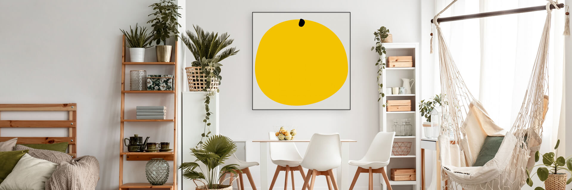 Oversized yellow boho art hanging in neutral boho apartment