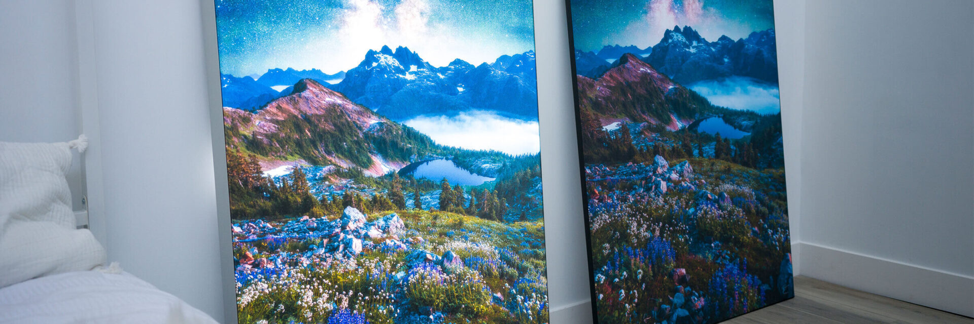 Identical nature photos are displayed side by side in a bedroom. The left image is backlit with a Lightbox. The right image is displayed traditionally on an Infinity Frame.
