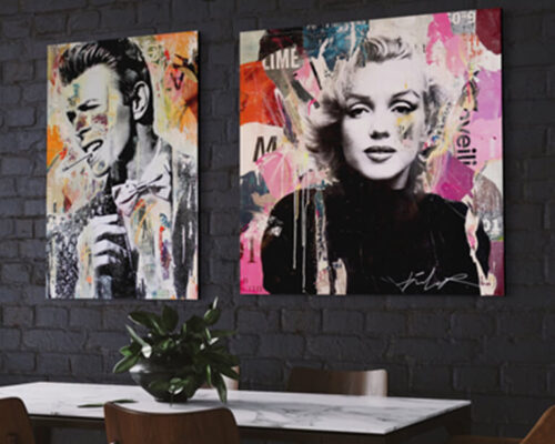 Pop singer wall art featuring David Bowie and Marilyn Monroe hang side by side on black brick wall in modern dining room