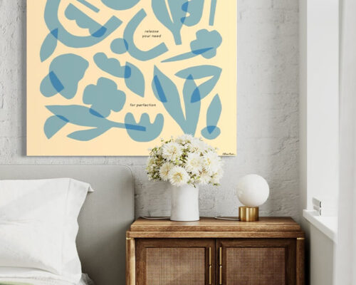 Massive light blue minimal wall art featuring layers of geometric shapes and flowers hangs on whitewashed brick wall above boho bed and side table.