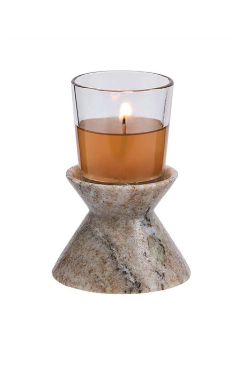 Stone candle holder with a tan pillar candle shown on a white background.