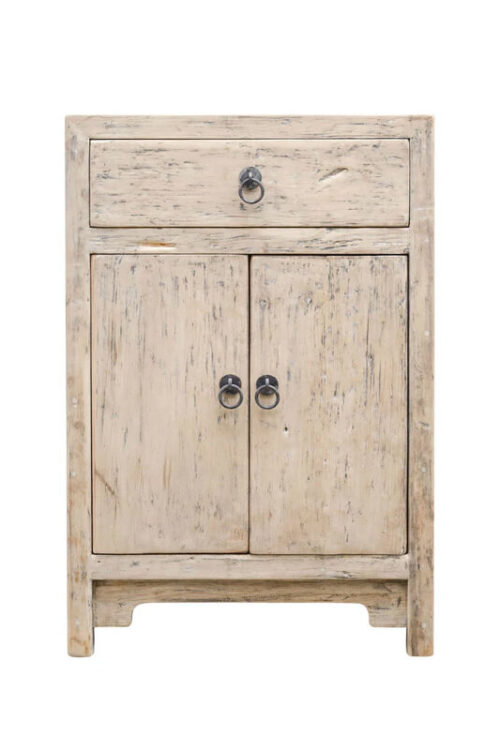Natural wood cabinet with clean lines and warm tones, styled in a neutral coastal interior.