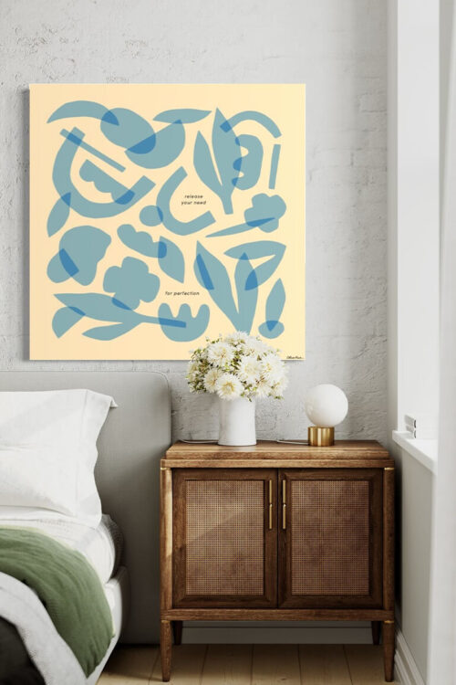 Massive light blue minimal wall art featuring layers of geometric shapes and flowers hangs on whitewashed brick wall above boho bed and side table.