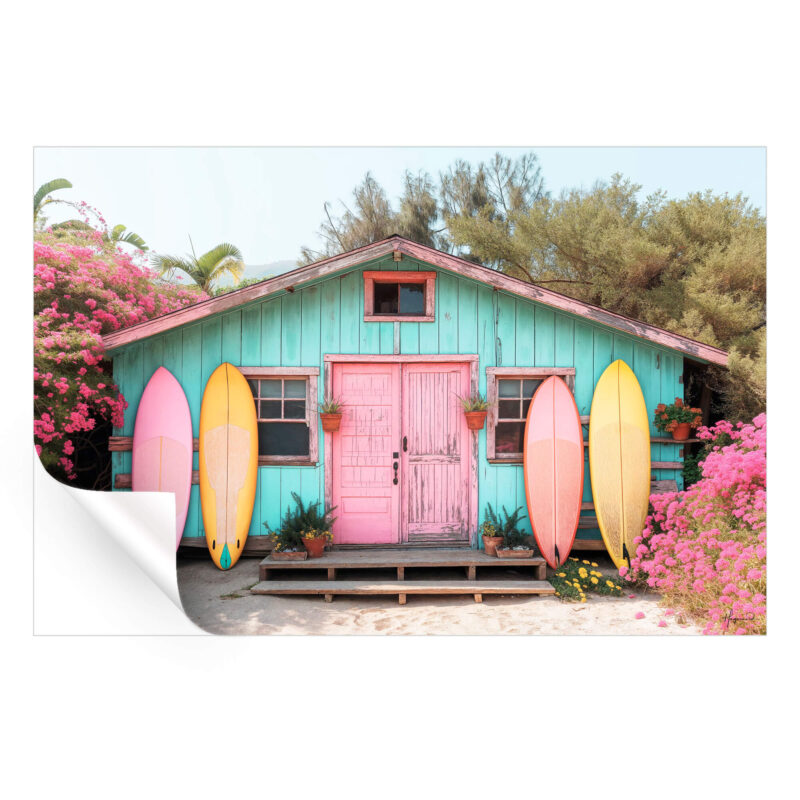 Turquoise beach hut with a pink door, surrounded by blooming flowers and colorful surfboards.