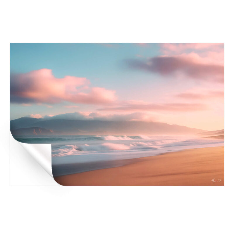 Dreamy beach at dusk with gentle waves, pink clouds, and mist-covered mountains.