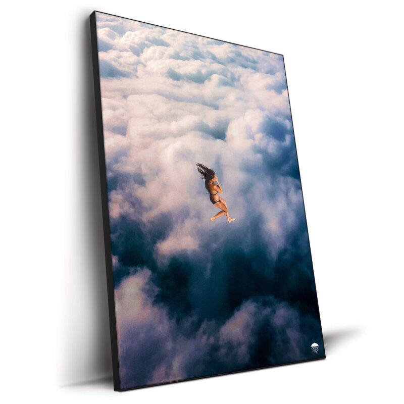 Woman diving in fluffy clouds in surreal collage.
