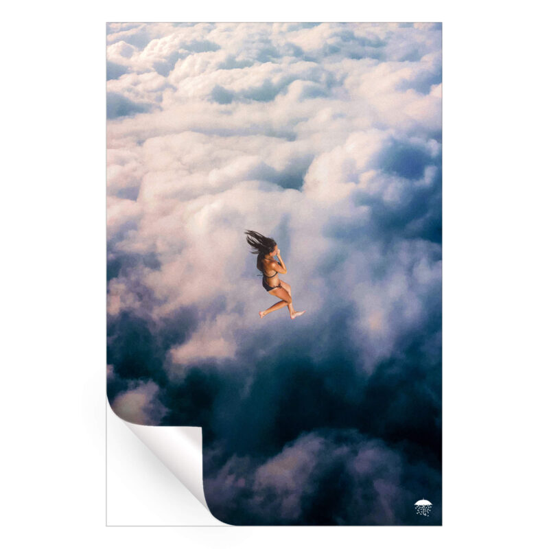 Woman dressed in bikini swimming in fluffy blue and white clouds.