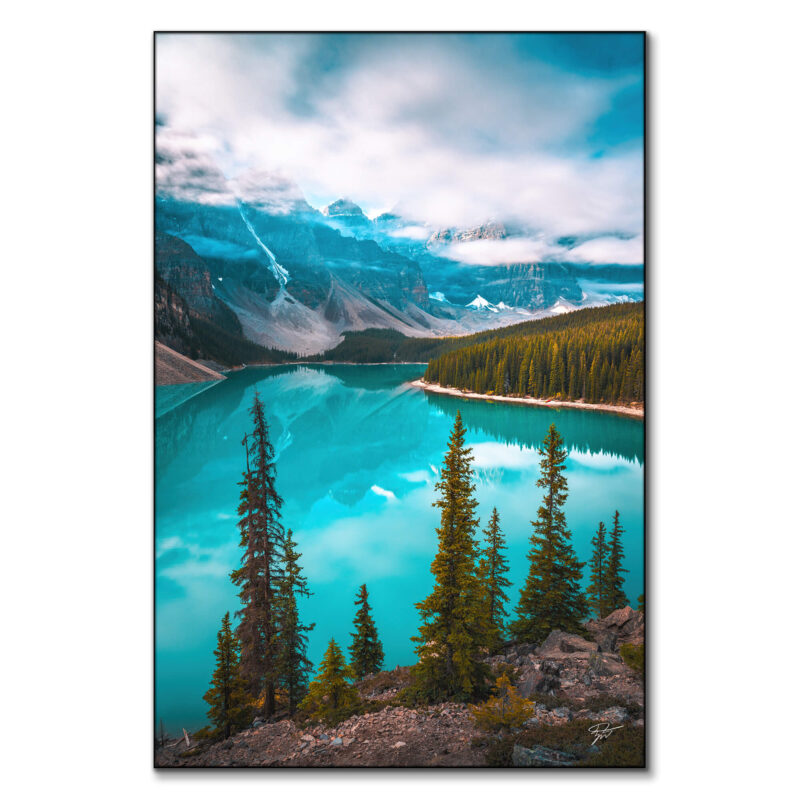 Moraine Lake in Banff National Park, Alberta, with turquoise waters reflecting towering peaks and lush pine forests.