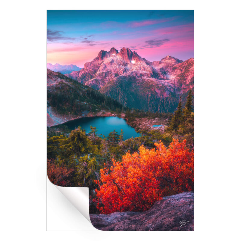 Dusk scene in the North Cascades, Washington, featuring rugged peaks, an alpine lake, and vibrant autumn foliage under a pink twilight sky.