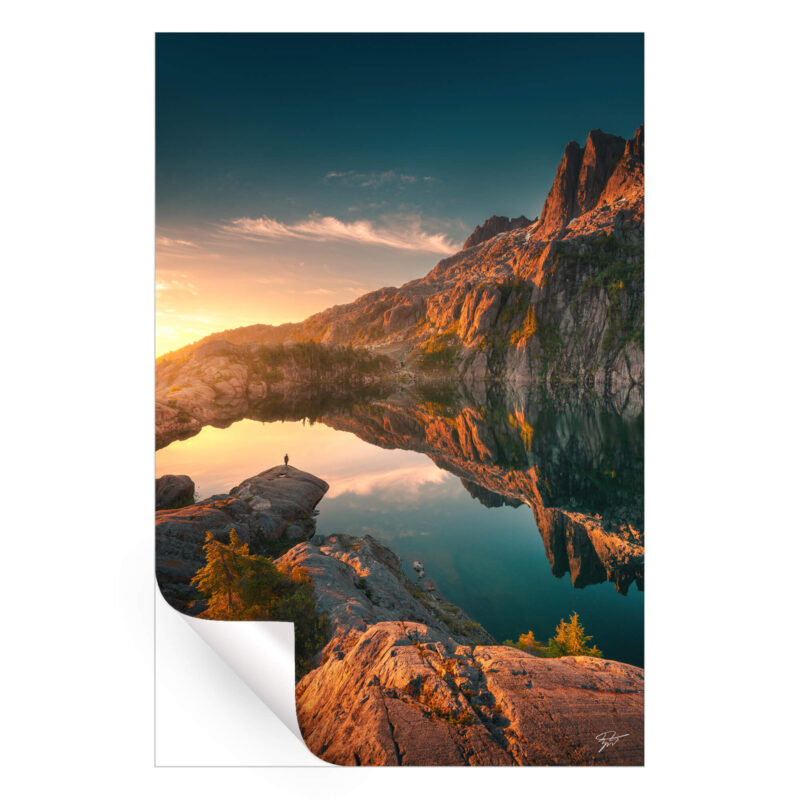 Lone figure at by a pristine mountain lake in British Columbia, Canada.