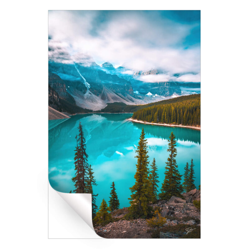 Moraine Lake in Banff National Park, with waters reflecting towering peaks and lush pine forests.