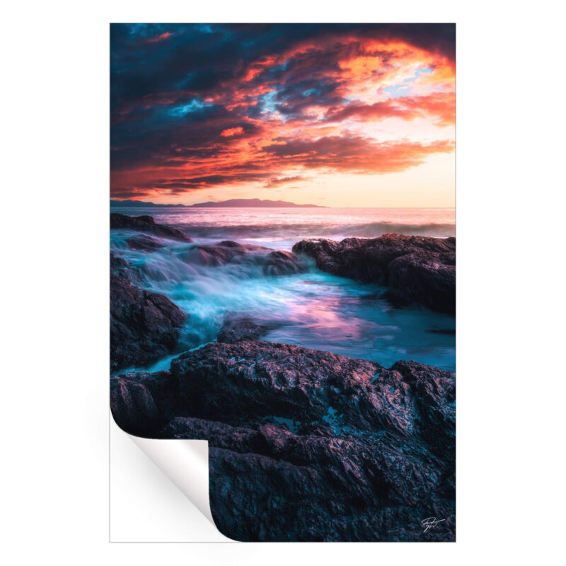 Sunset over the rugged coast of Tofino, British Columbia, with vibrant sky colors and crashing waves.